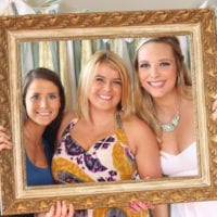 Casey poses with friends at her bridal shower photo booth.