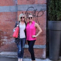 Bridget and Casey snap a pic in front of a rustic NYC brick wall.
