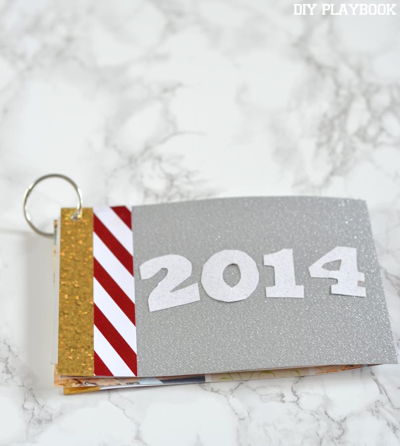 Next, add a fun cover to your Christmas Card photo book. We love this glittery silver paper!