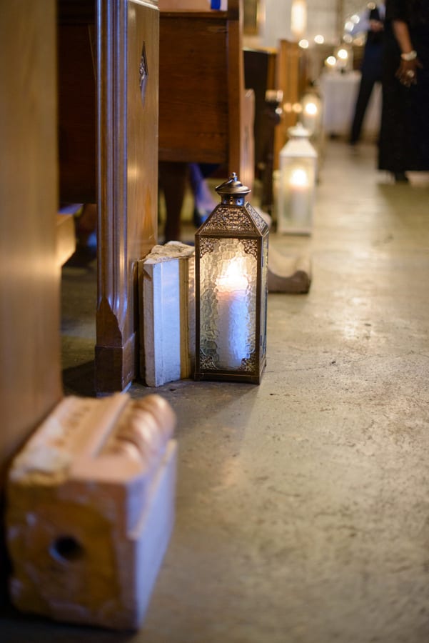 These candle lanterns along the aisle add a whimsical element to the wedding.