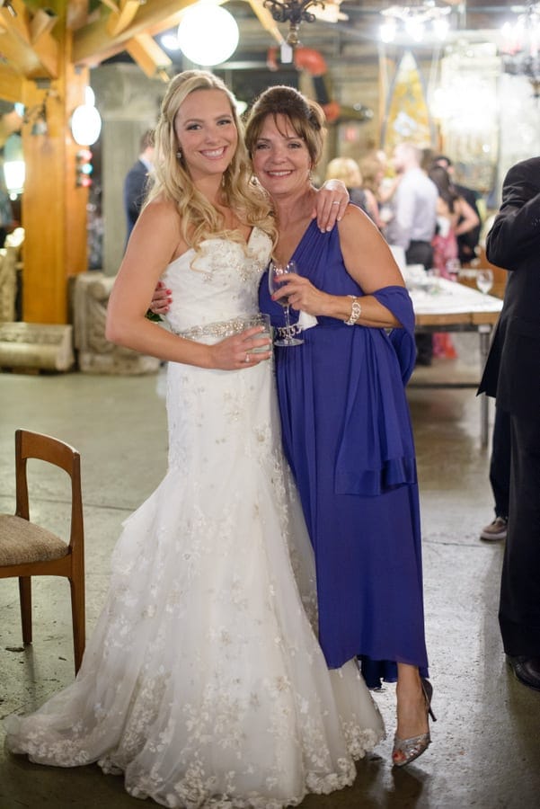 The bride poses with her mother at the wedding reception.
