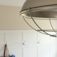 This classic board and batten wall looks great with the modern light fixture.