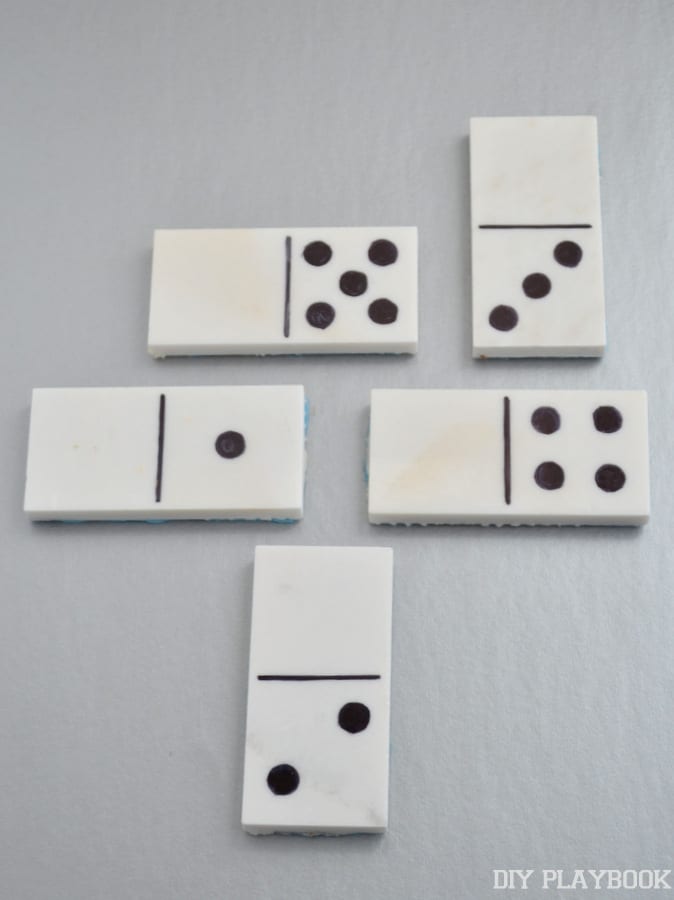 Draw on any design using the sharpie onto the blank marble tiles to make domino pieces.