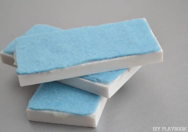 Cut and hot glue felt onto the bottom of the DIY domino pieces.