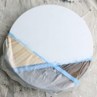 Large section of the wooden plant stand base painted white.