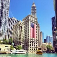 The Chicago flag pops against the river in the summertime.