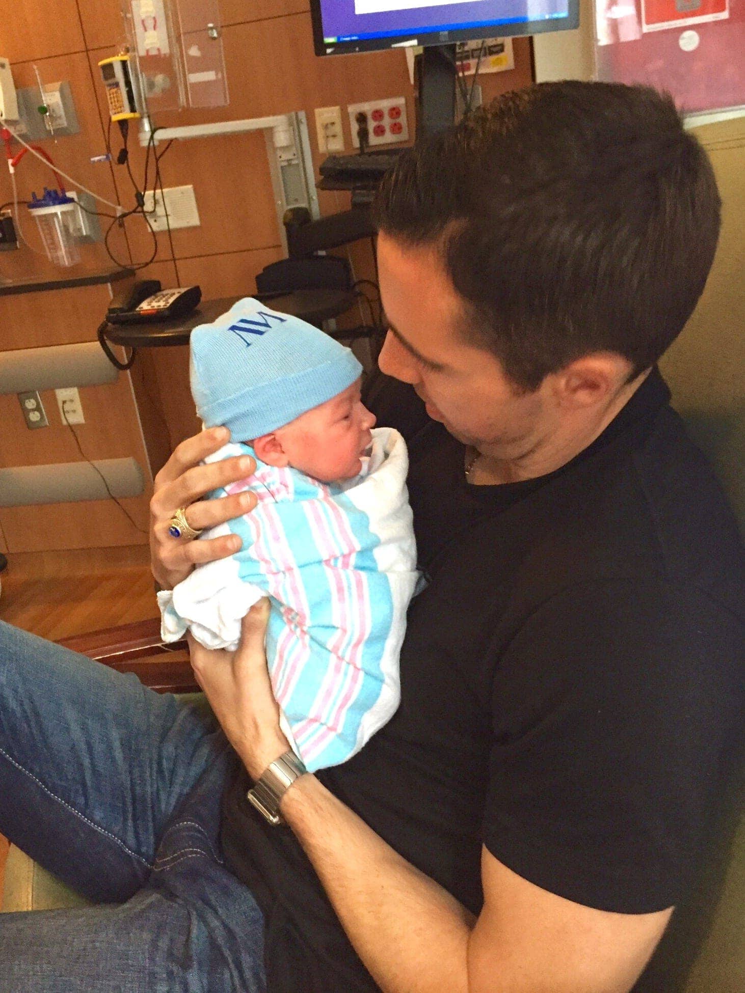 A father holding his baby for the first time is a happy moment.