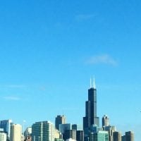 The Chicago skyline is blue and bright.