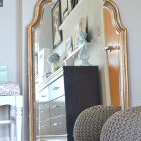 This large mirror has elegant gold rims.