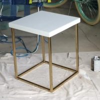 This chic end table is sleek and painted gold.