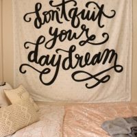 The cute tapestry adds wall decor to the dorm room.