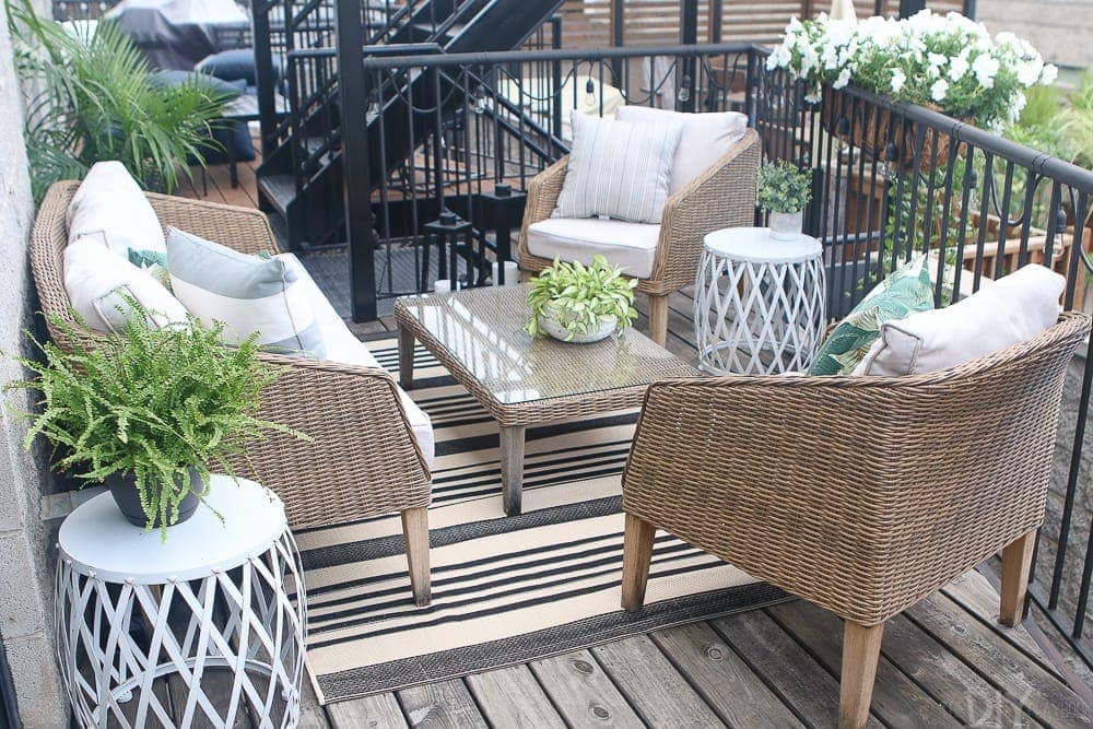 City patio space with small couch and chairs