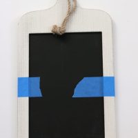Tape chalkboard sign to paint half with a bright colored paint.