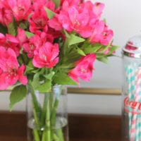 These fresh flowers add to the overall living room decor.