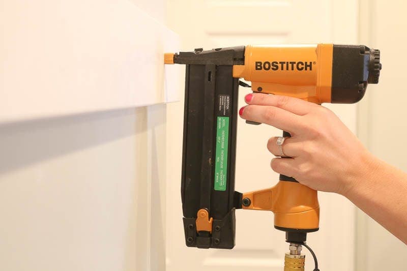 Using a simple nail gun to install board and batten walls in the hallway. 