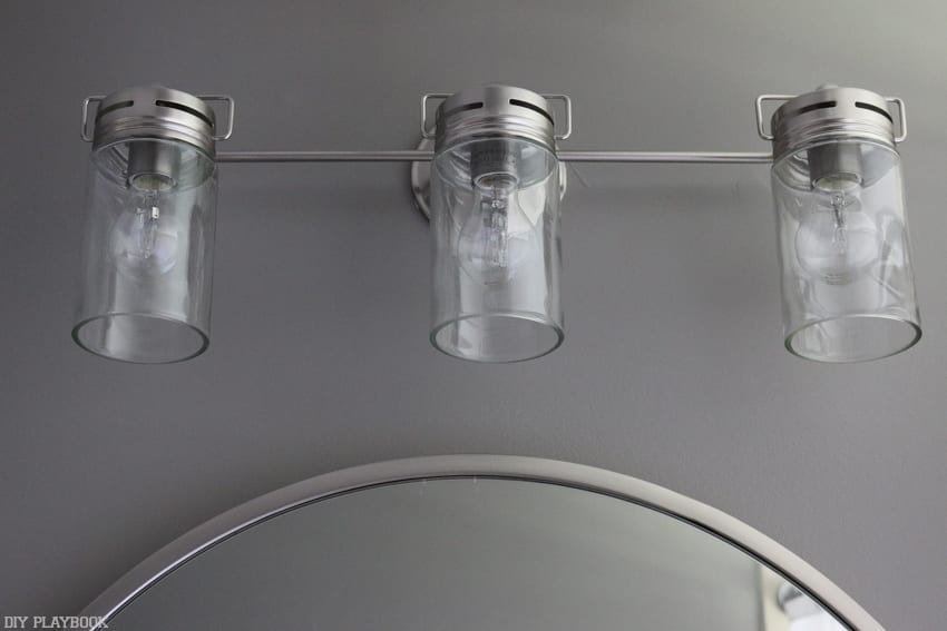 New light fixture in the bathroom makeover--vanity lights with silver accents. 