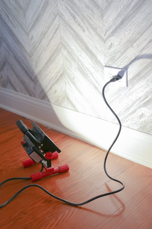 Shine a bright light on the wall to search for any air bubbles.