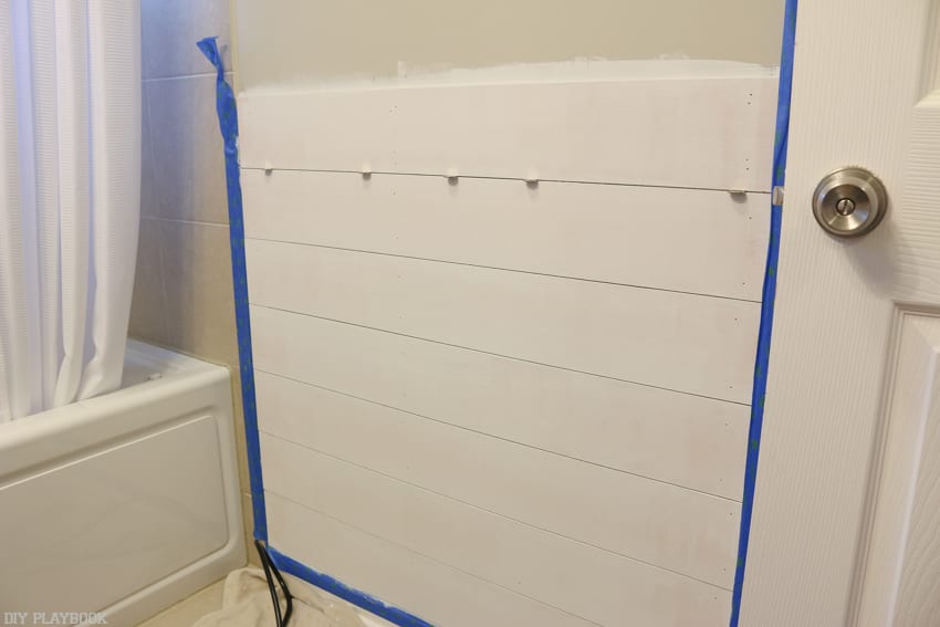 Hang the pieces of shiplap on the wall by nailing them in until secure.