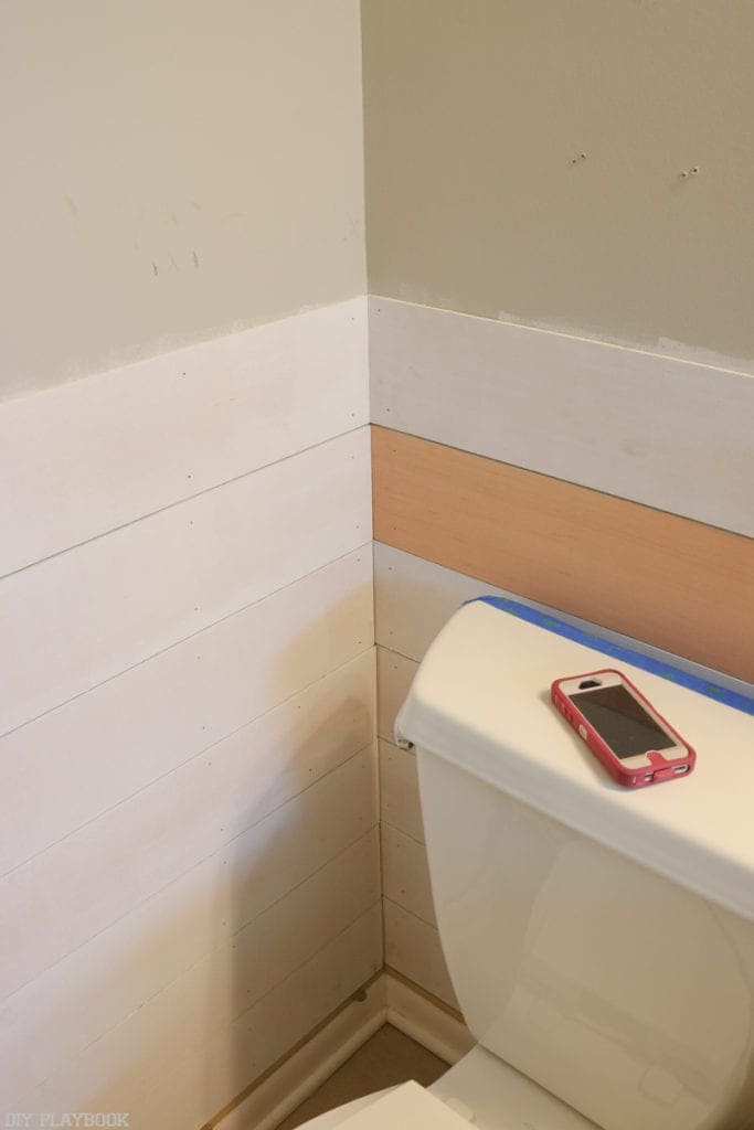 Continue hanging the pieces of shiplap on the other walls working from the top down.