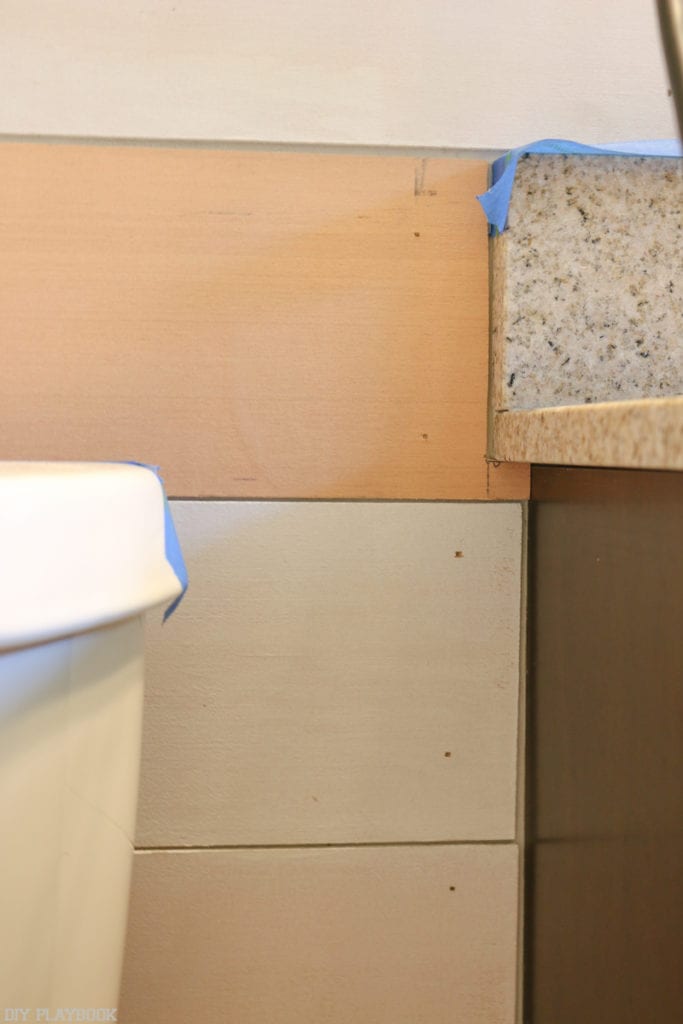 Making small cuts in the shiplap makes it easier to hang pieces around the vanity.