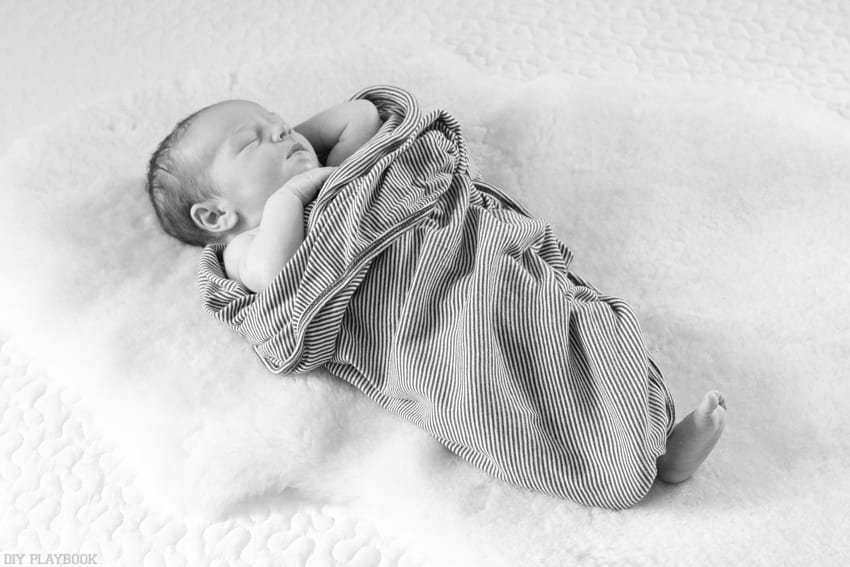 Babies are more comfortable being swaddled even in photos.
