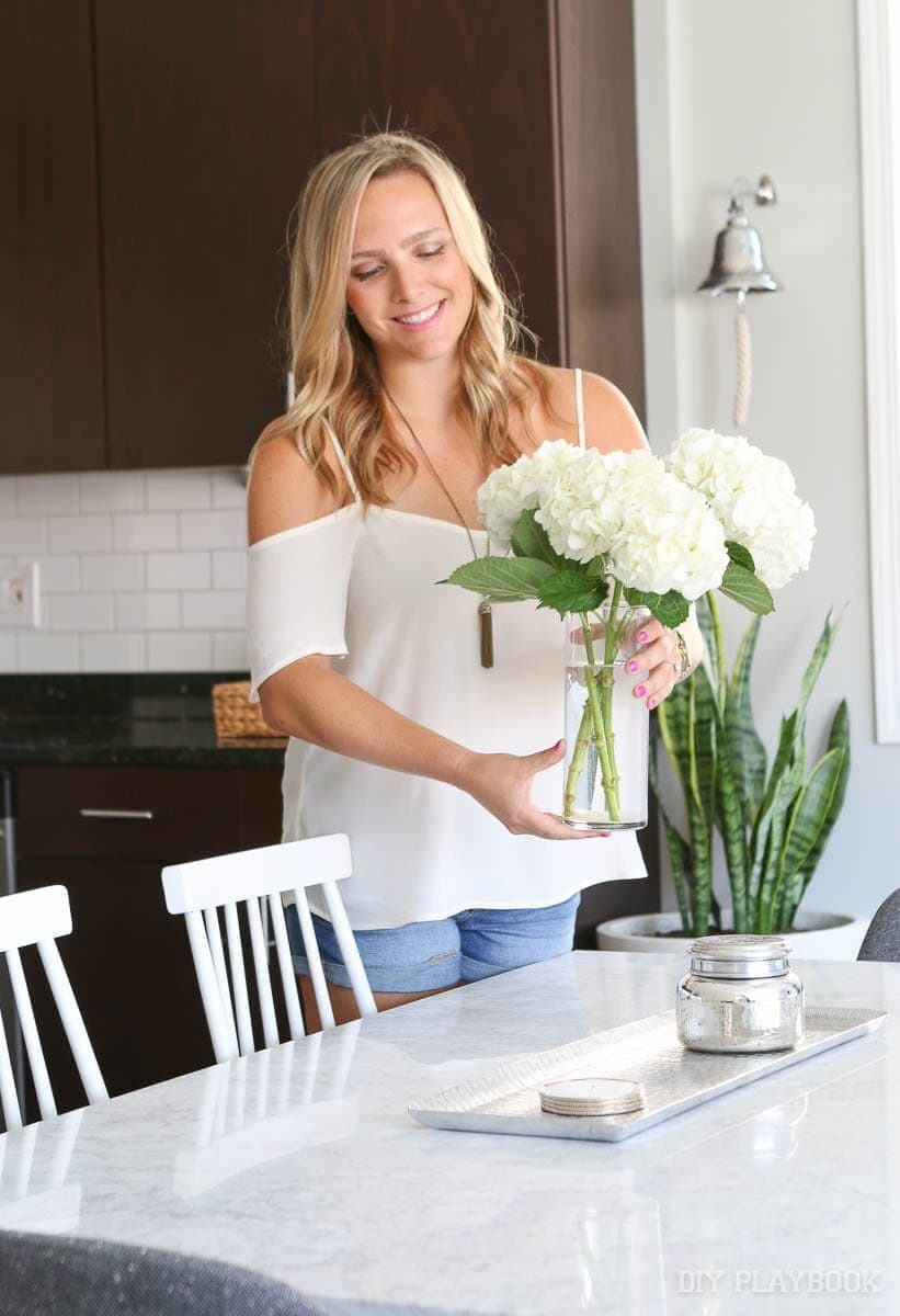 casey adding a special floral touch to the dining room