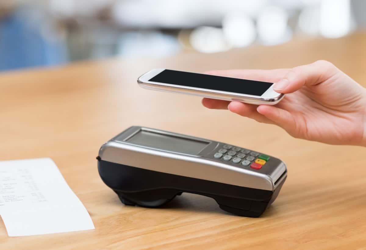 Hand uploading digital receipt via mobile app on an iphone