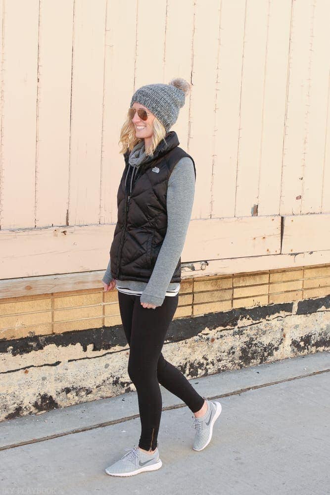 Bridget's favorite Athleisure Pieces to Wear Anytime inlcude grey sneakers, black leggings and a grey pull over hoodie 