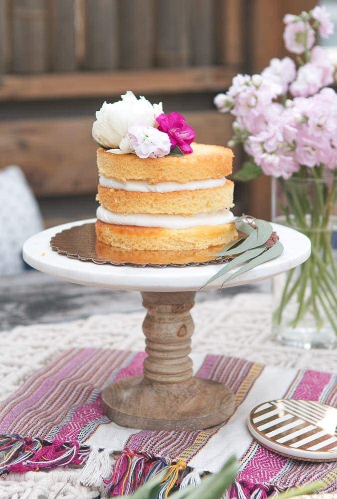 Add flowers and greenery to your cake and stand
