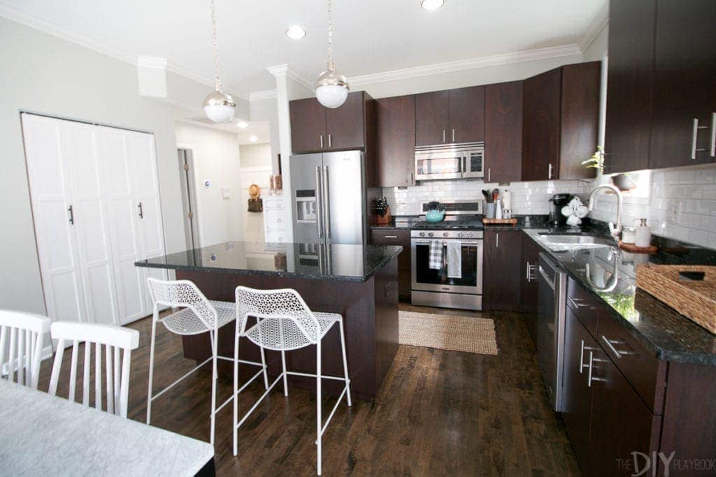 White mesh stools in a dark kitchen