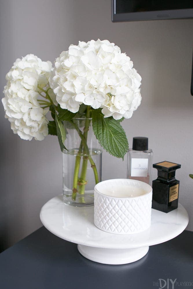 Flowers and candles accessorize the space.