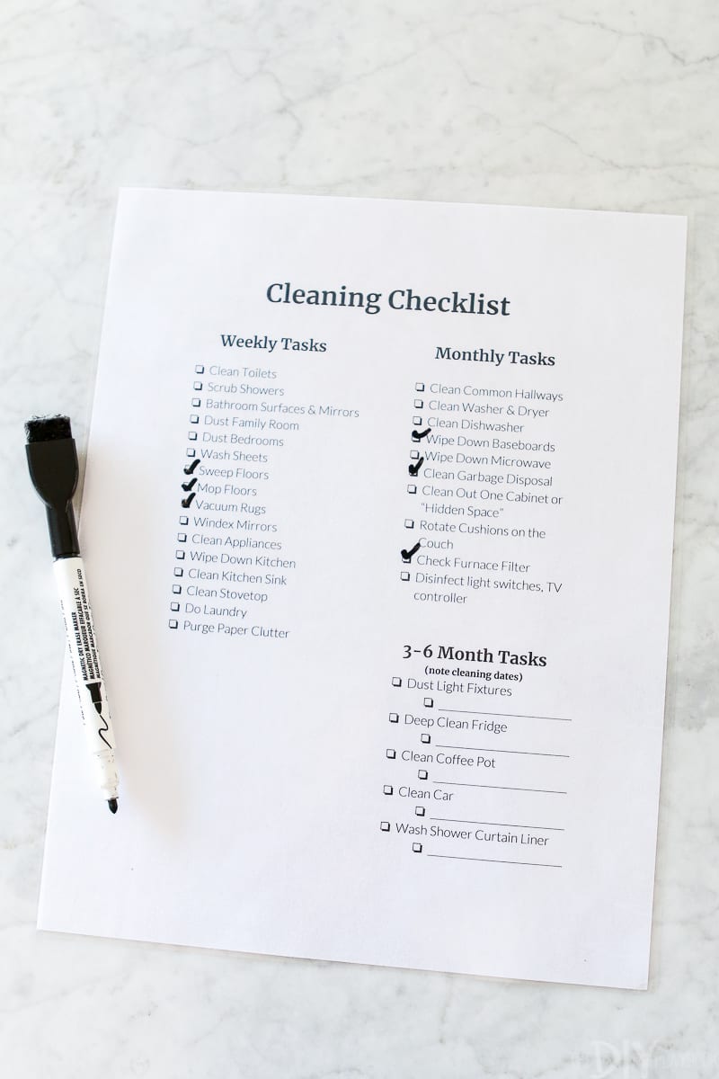 Crossing off cleaning tasks on my cleaning checklist