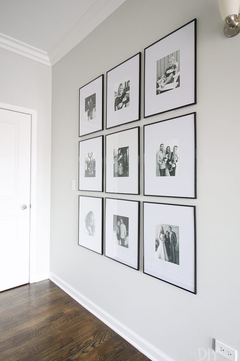 A symmetrical gallery wall in a long hallway