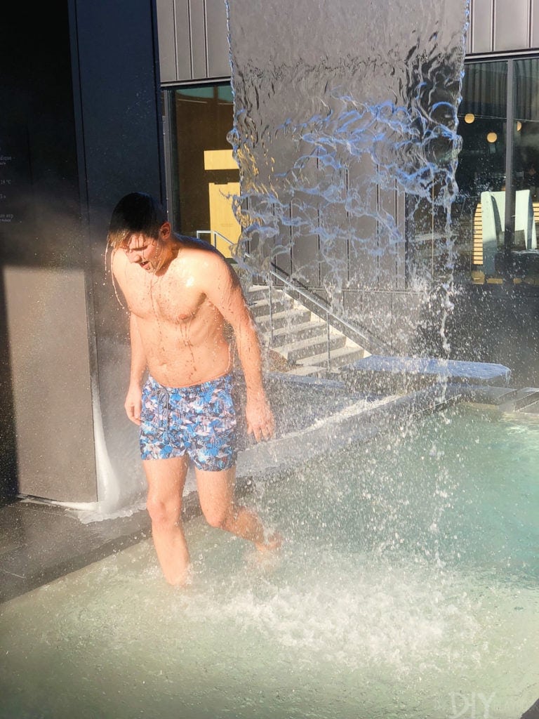 Finn underneath a waterfall