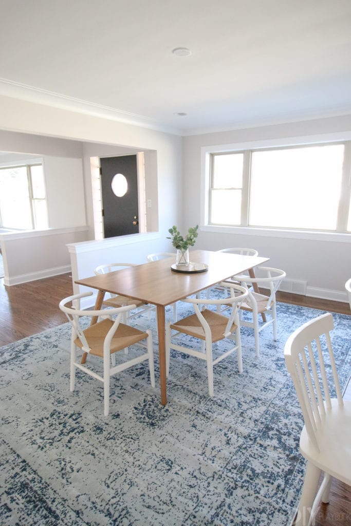 This dining room is still unfinished, but love the blue rug and wood table
