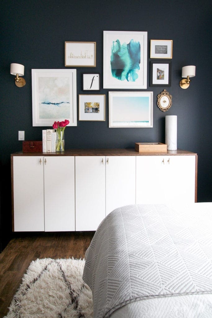 A fauxdenza cabinet with a gallery wall over it