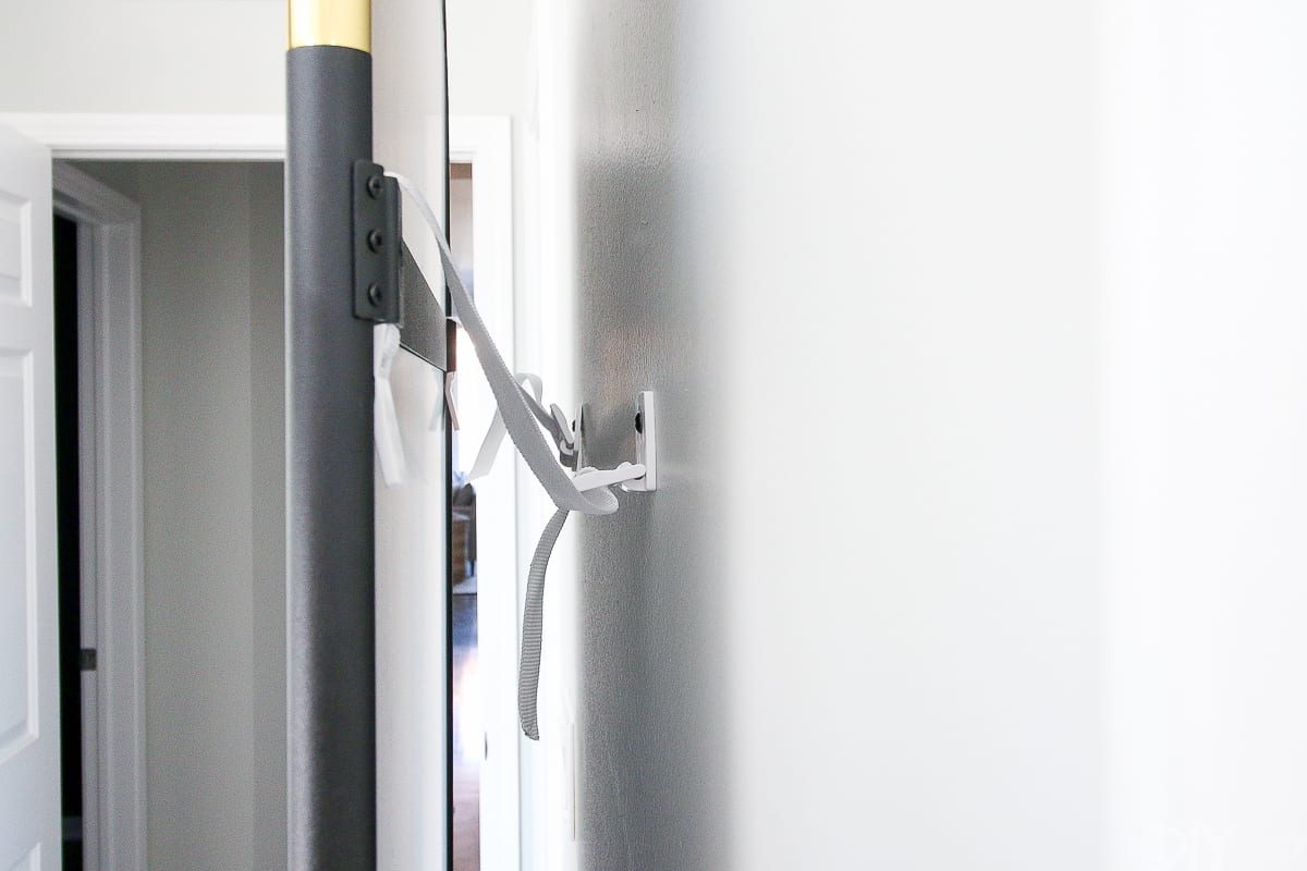 securing a leaning wall mirror with straps