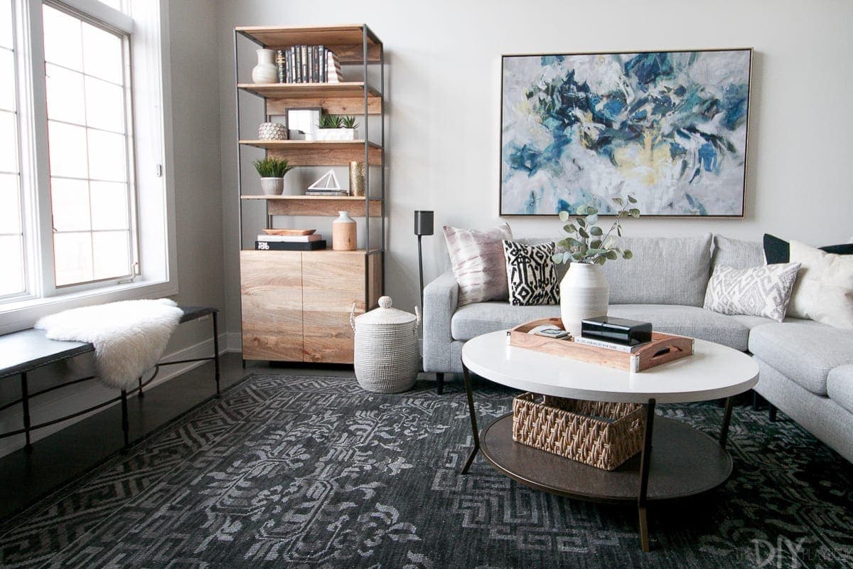 A family room with a white coffee table and gray sectional.