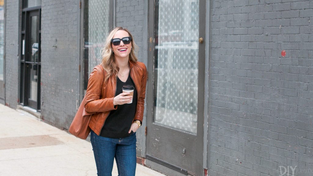Black sunglasses with a brown leather jacket
