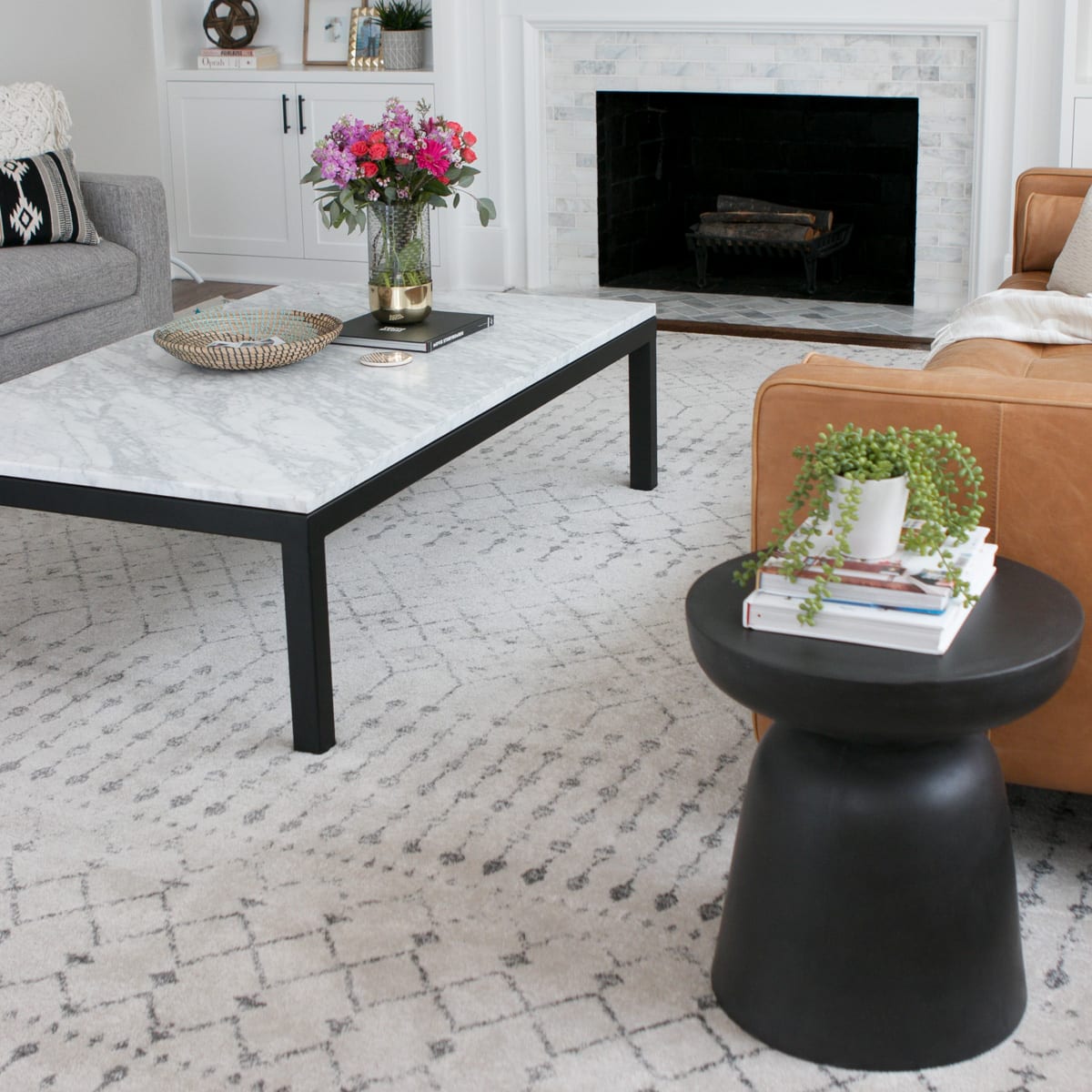 A black side table looks nice with a marble coffee table. 