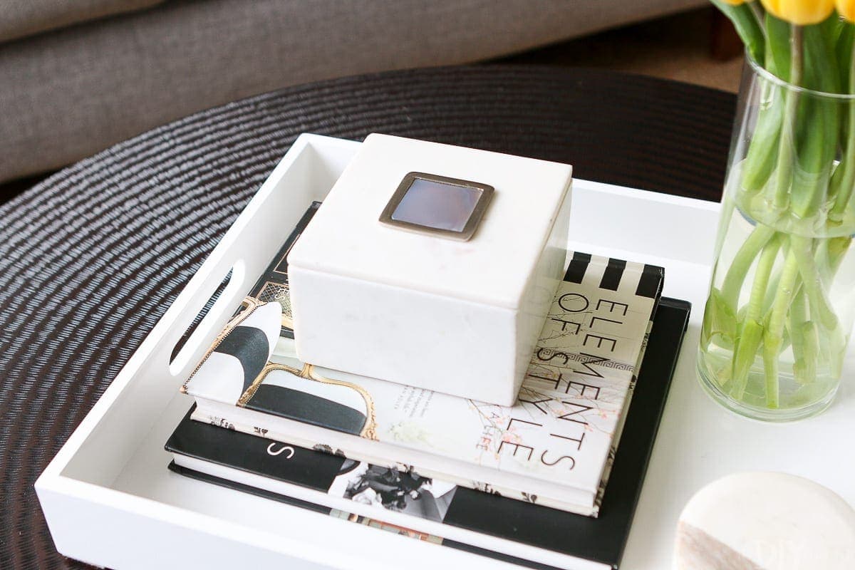 Adding a box on a coffee table book is a great idea for secret storage.