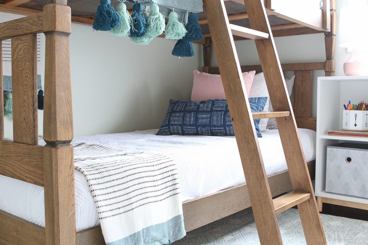 White, navy, and blush bedding works perfectly in this room. 