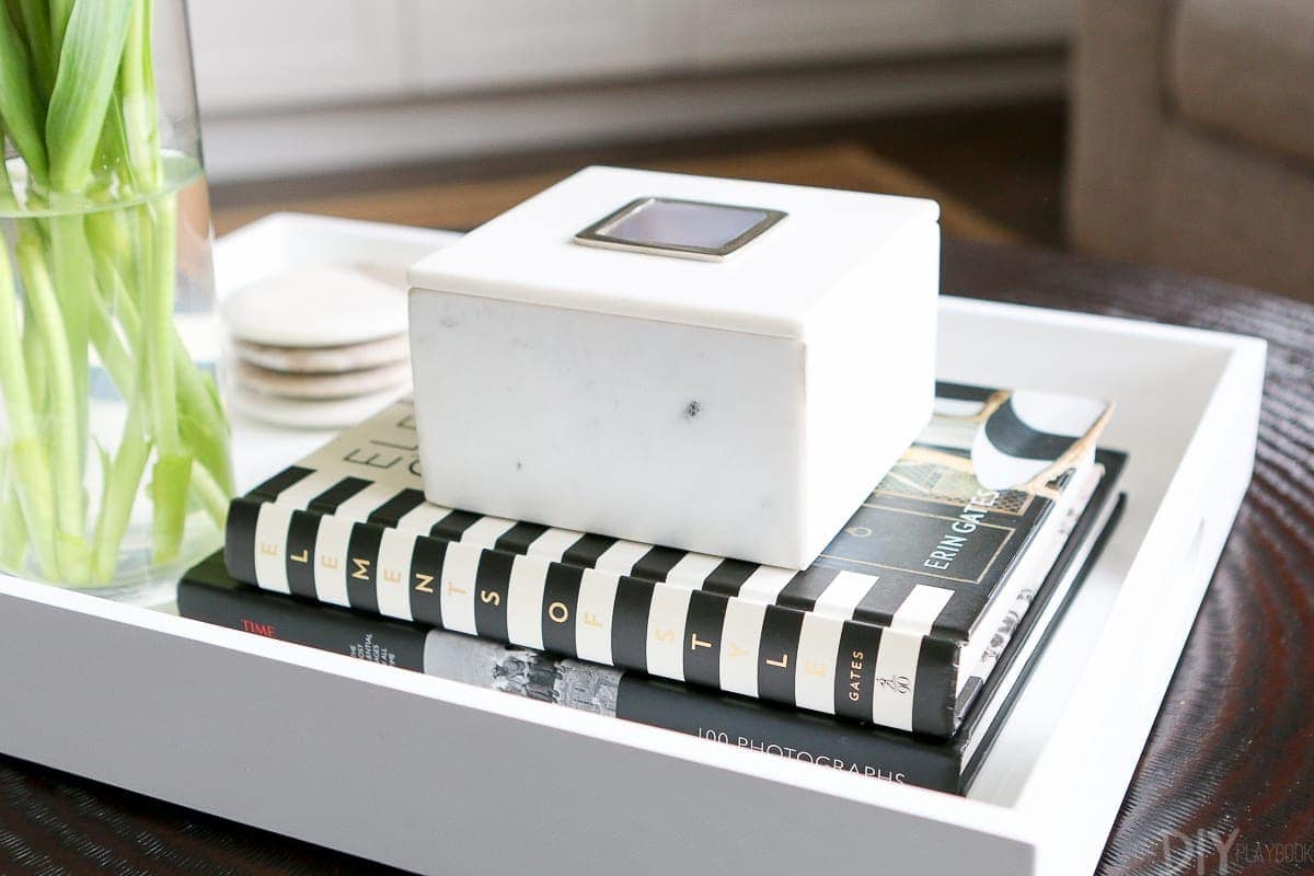 Coffee table books are a must to style a round coffee table.