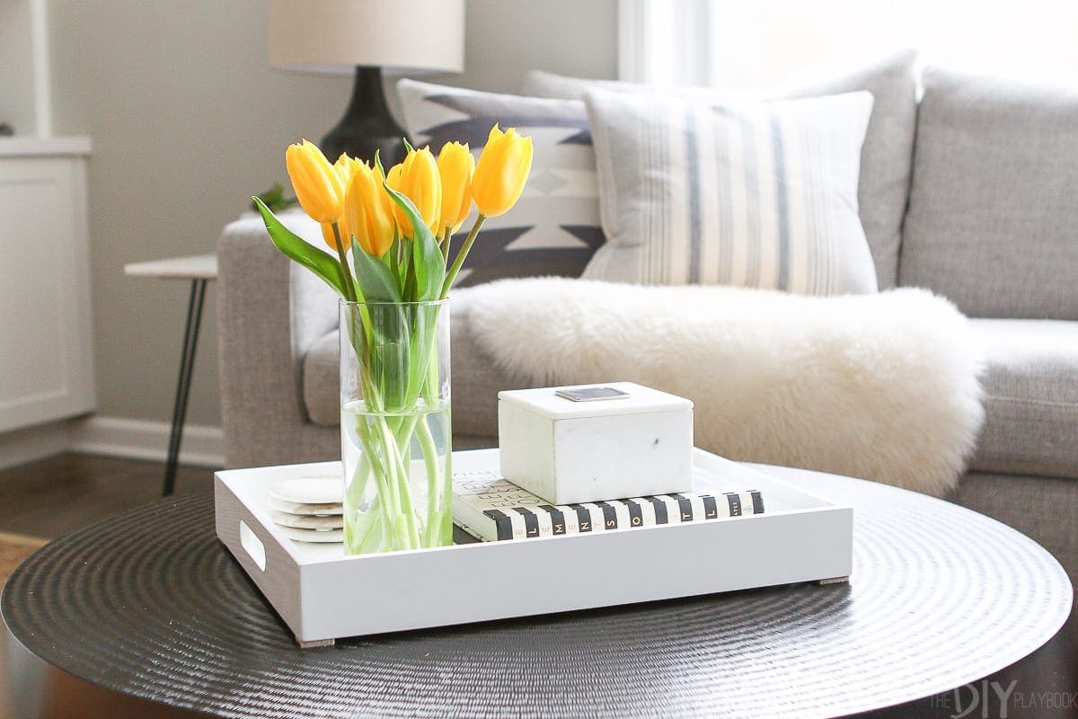 We always use a try when styling a coffee table because you can easily remove it when you need to use the table.