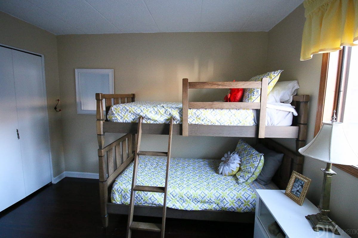 Brown bunkbeds and quilts. 