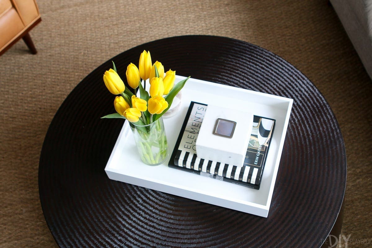 A vase of fresh flowers is always a good idea when you style a round coffee table.