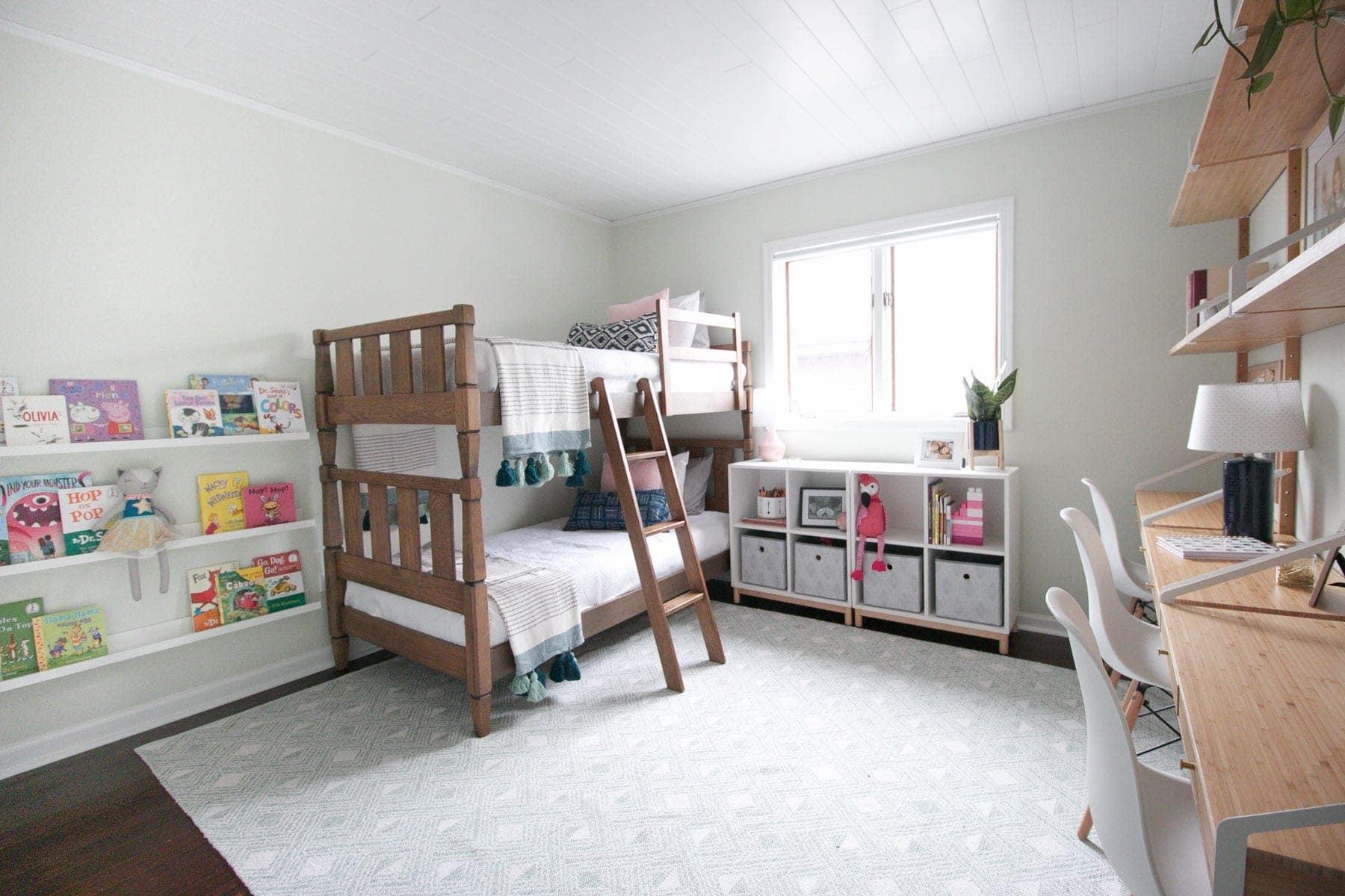 A bright kids' room space with storage and bunkbeds 