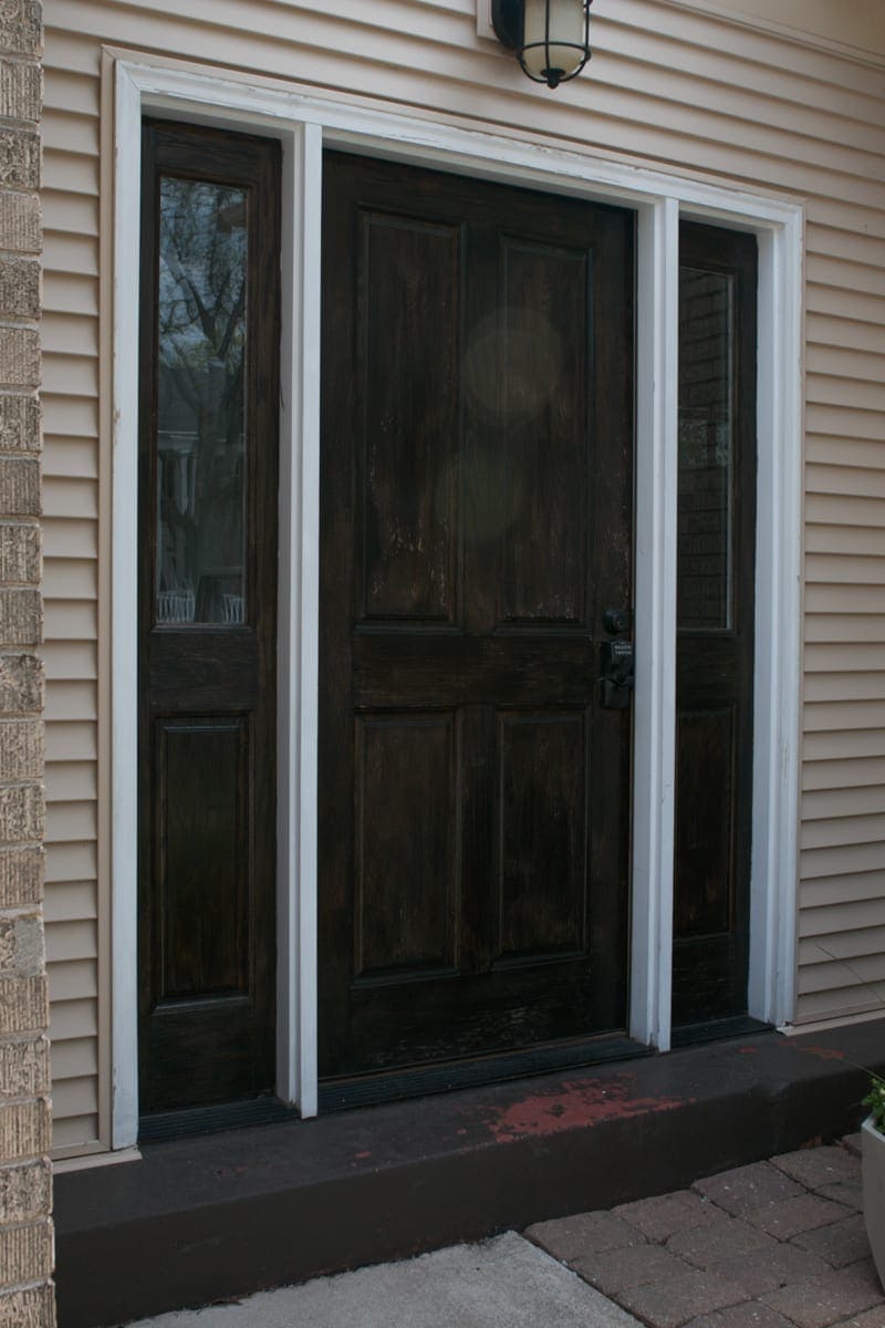 A brown door with chipping paint needs some TLC 