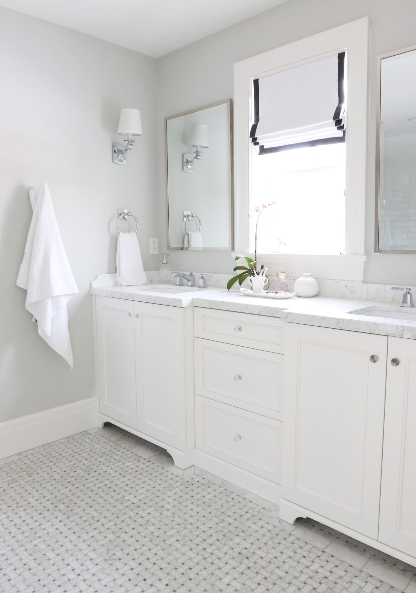 A bathroom inspiration photo from Studio Mcgee with basketweave floors and a white vanity