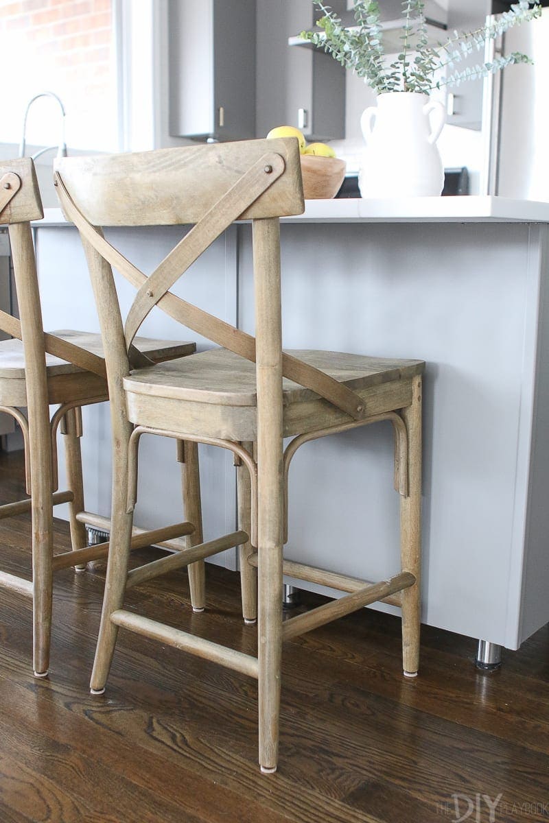 Wood stools from World Market warm up this gray kitchen